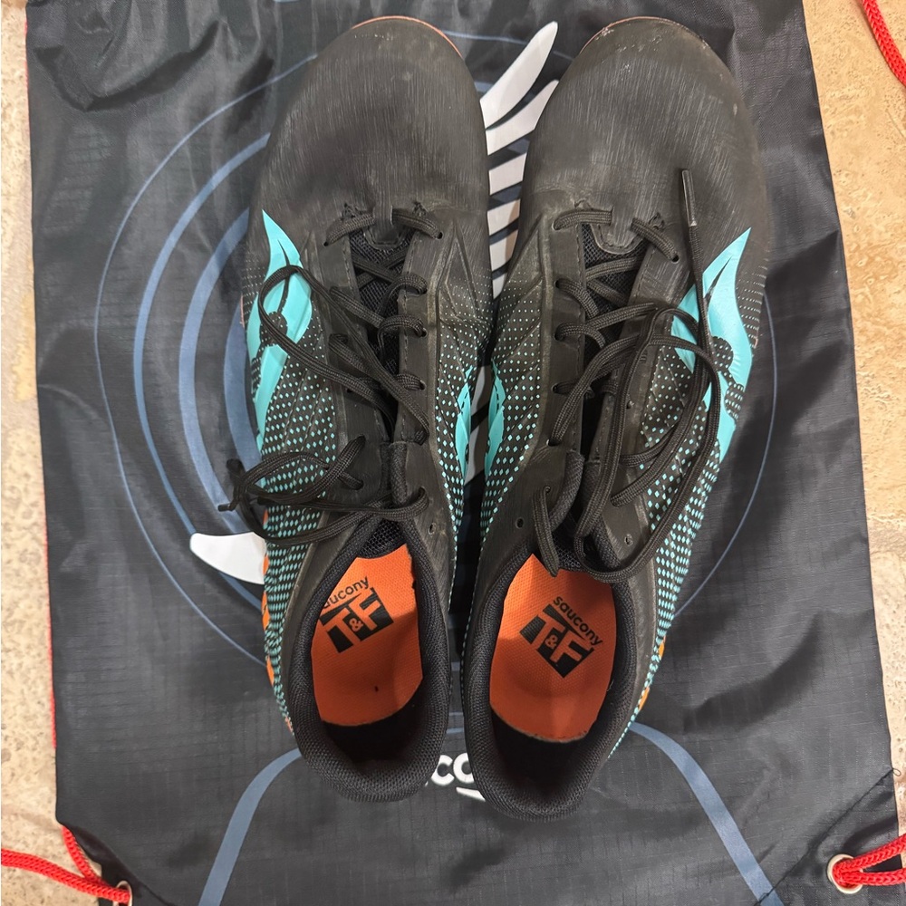 Black and Teal Saucony track and field spikes